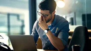 Hombre cansado frente a la computadora